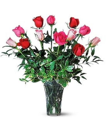 Bouquet of red and pink roses in a clear glass vase