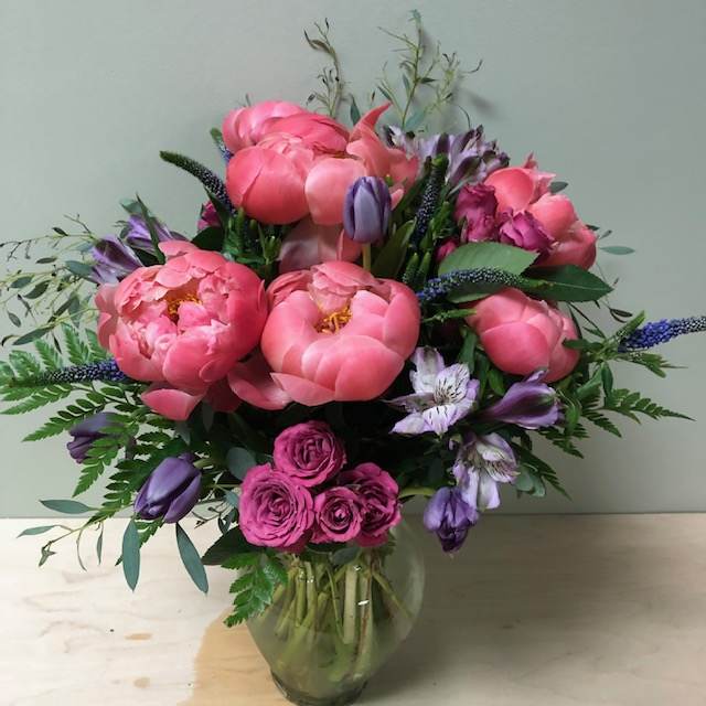 Pink and purple mixed bouquet in a clear glass vase