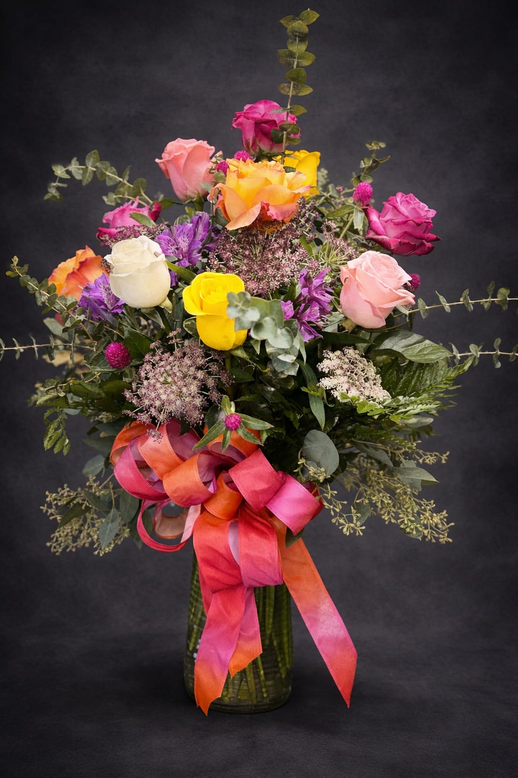 My Rainbow - A vase arrangement filled with greenery and assorted colors of roses. (12 roses)