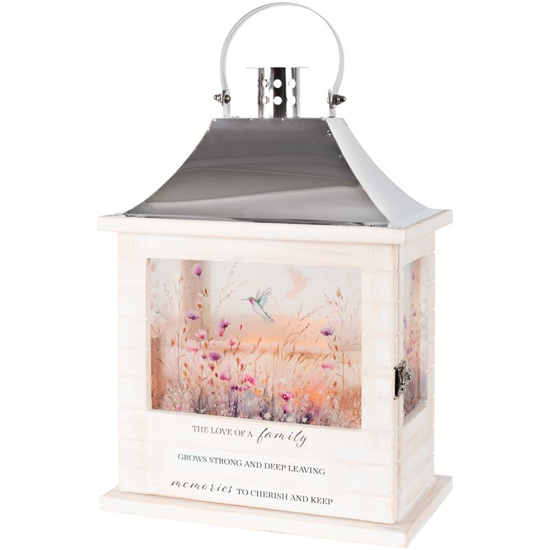 "Love Of A Family" Wood Slat Lantern - Our Wooden Slat lanterns are made with quality wood with a stainless steel finish top. They come inscribed with sentimental quotes amid beautiful artwork on all four sides and a charming flameless LED candle. Suitable for hanging or use as a freestanding item. Recommended as an accent in floral arrangements for many occasions. They are weather friendly! 3 AAA batteries are NOT included.  Lantern Reads: "The love of a family grows strong and deep leaving memories cherish and keep"  W: 8.75" H: 12.5" D: 5.25"