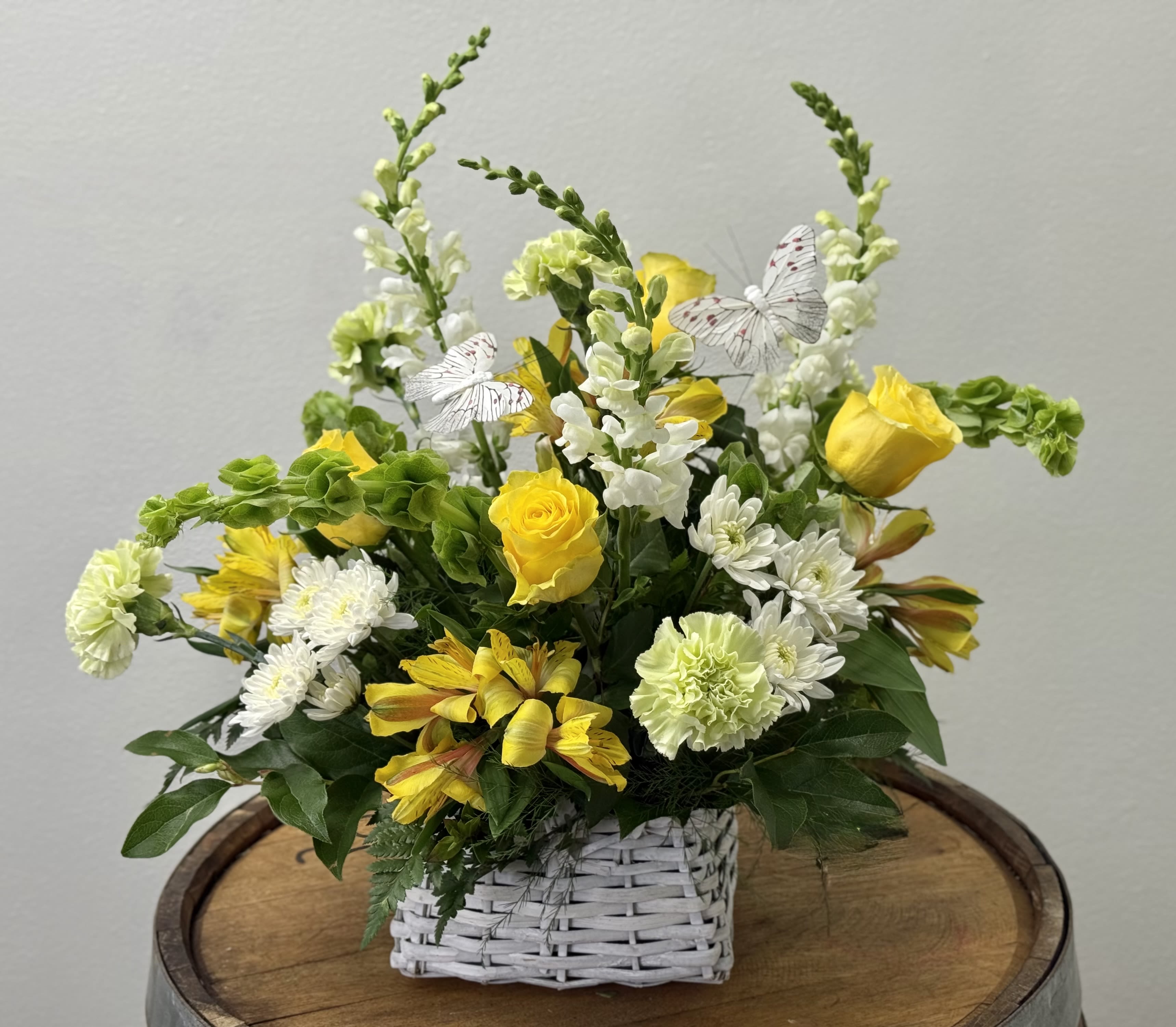 Buttercup Daydream - "A little sunshine, a little magic and a place to land." Golden roses and butter-yellow blooms dance among soft whites and fresh greens, while delicate  butterflies flutter like pages from a forgotten book. Buttercup Daydream feels like warm light on your skin, a quiet afternoon and story you never quite want to end.