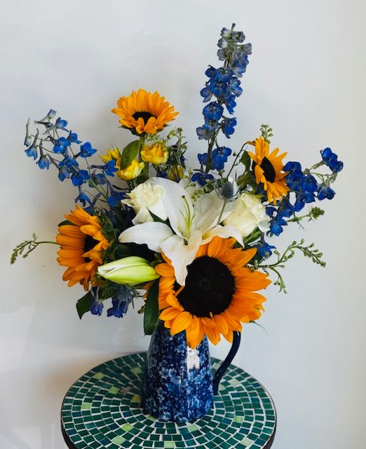 Chaparral Cheer - A bright and cheerful arrangement to spread some cheer to those needing a pick me up. Roses, Lilies, and seasonal greens in a Moroccan ceramic cube.*This product contains lilies, which are very toxic to cats, please advise if recipient has cats and I will replace the lilies with other blooms