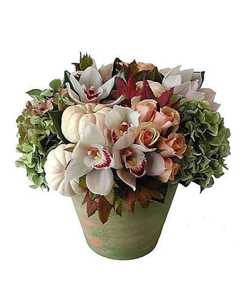 Autumn arrangement with white orchids, peach roses, hydrangea, and mini pumpkins in a green pot