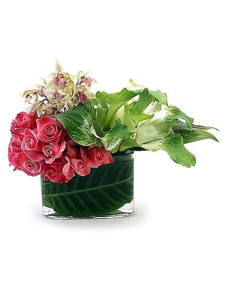 Low rectangular vase with pink roses, green and white calla lilies, and orchids arranged asymmetrically