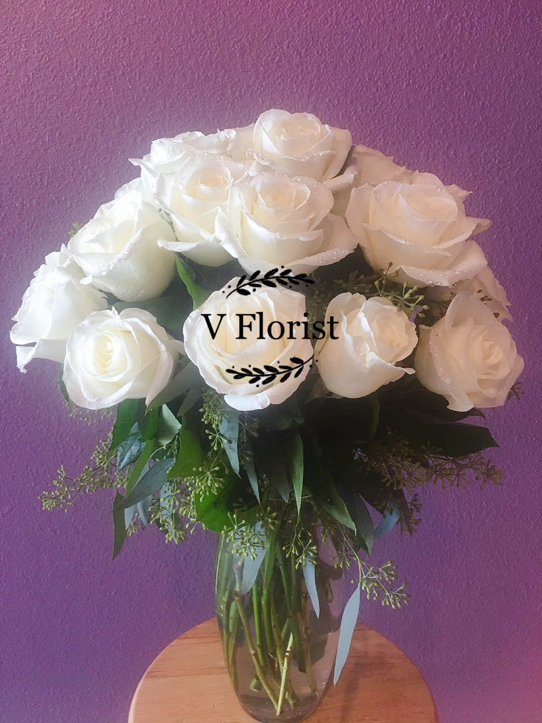 White rose bouquet in a clear glass vase