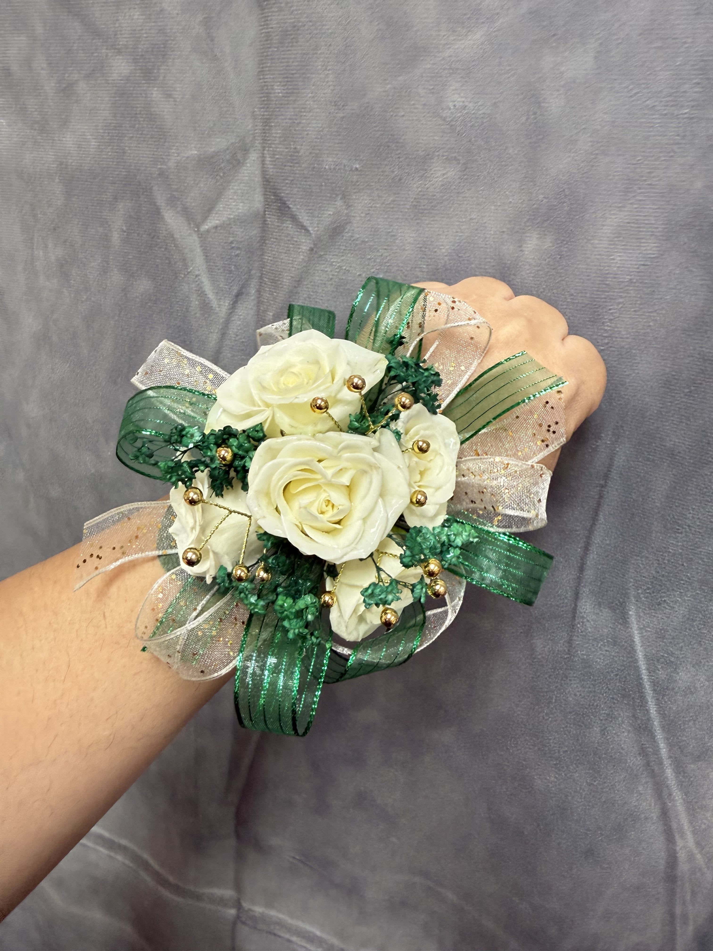 Emerald Green Gold White spray roses corsage - White spray roses with gold , emerald green ribbon  and gol accents round corsage with pearl bracelet 