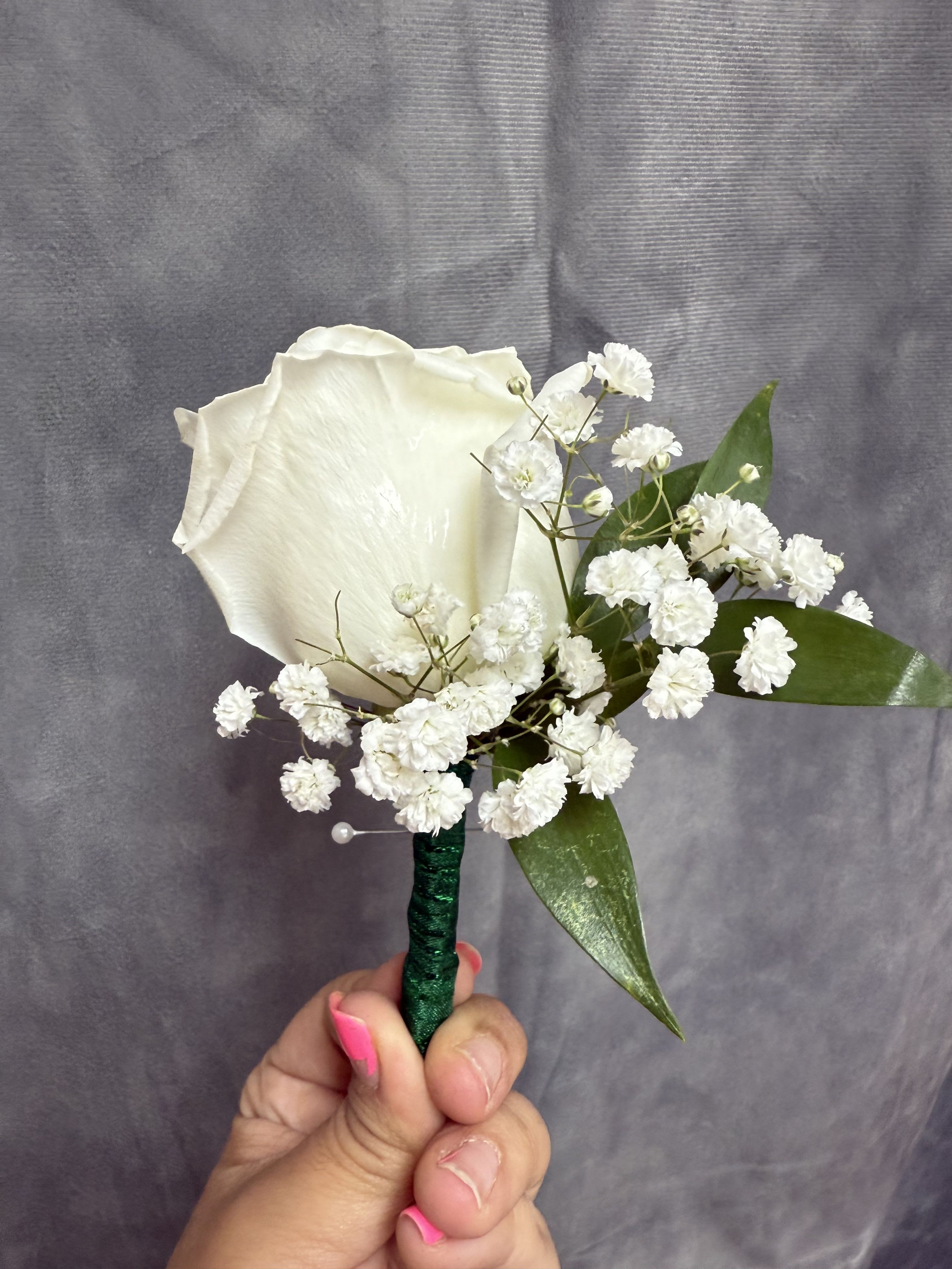 Emerald green white rose boutonnière  - White rose with emerald green baby breath boutonnière wrapped with emerald green ribbon 