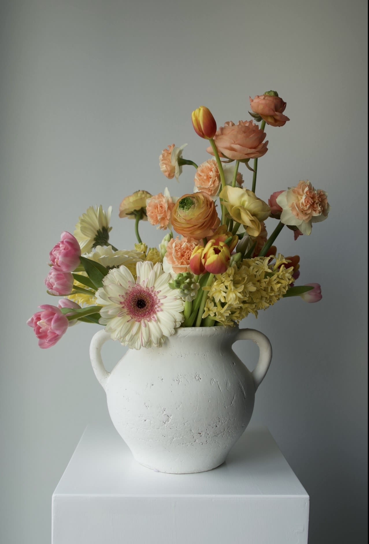 Dopamine Garden - A vibrant spring arrangement designed to bring instant joy. Featuring tulips, ranunculus, gerbera, hyacinth, and seasonal blooms in warm peach, yellow, and blush tones.  Fresh, playful, and full of light — a perfect way to brighten someone’s day and celebrate the season. 