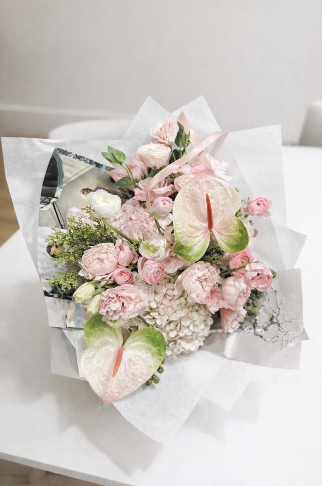 Spring Garden - A soft, romantic bouquet in delicate blush and ivory tones, inspired by a blooming spring garden.  Featuring lush peonies, ranunculus, hydrangea, anthurium, and fresh seasonal greens, it feels full, airy, and gently expressive. A subtle floral scent adds a fresh, uplifting touch. 