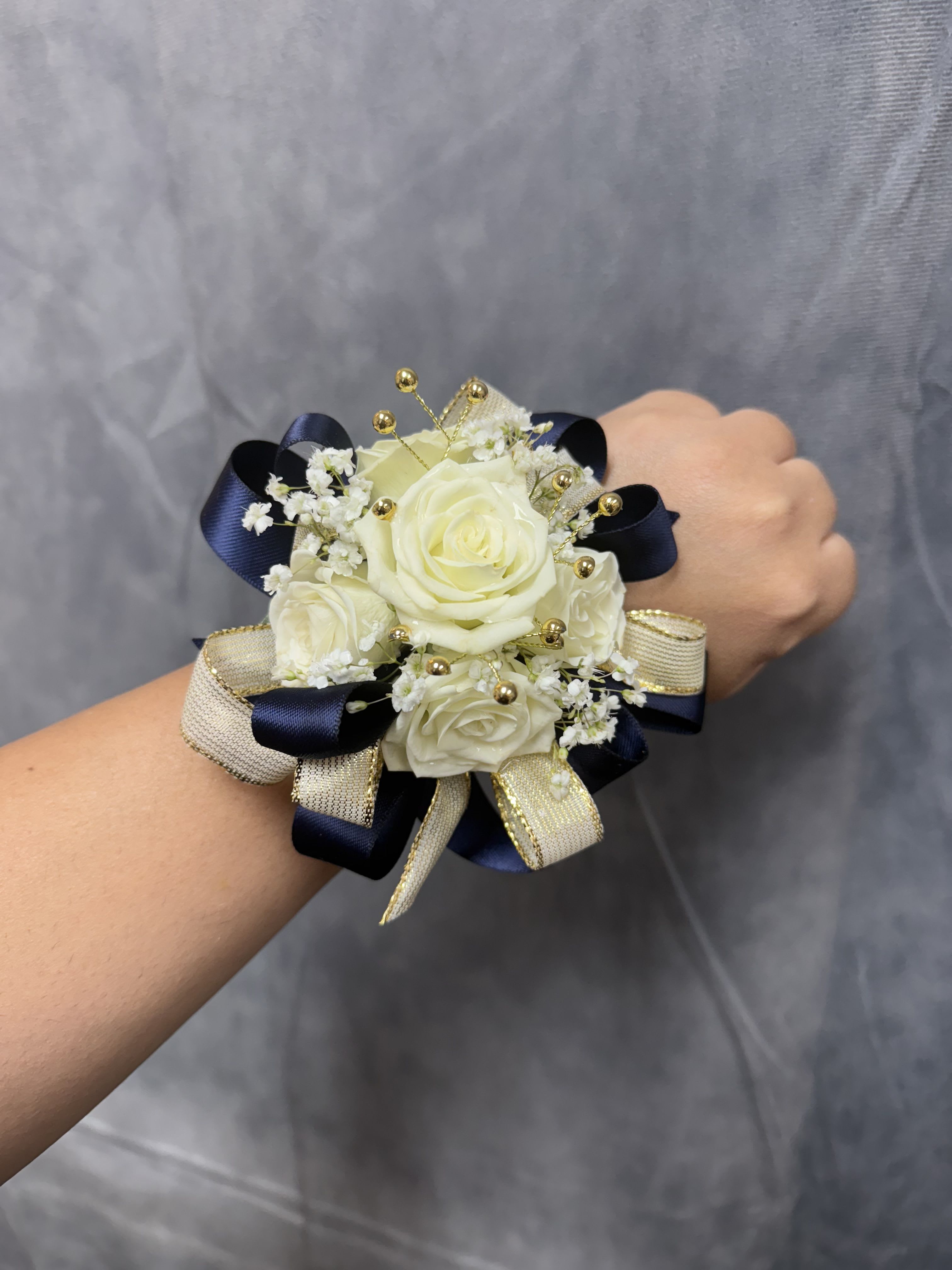 Navy Gold White spray roses corsage  - White spray roses with navy , gold ribbon and gold accents round corsage with pearl bracelet 