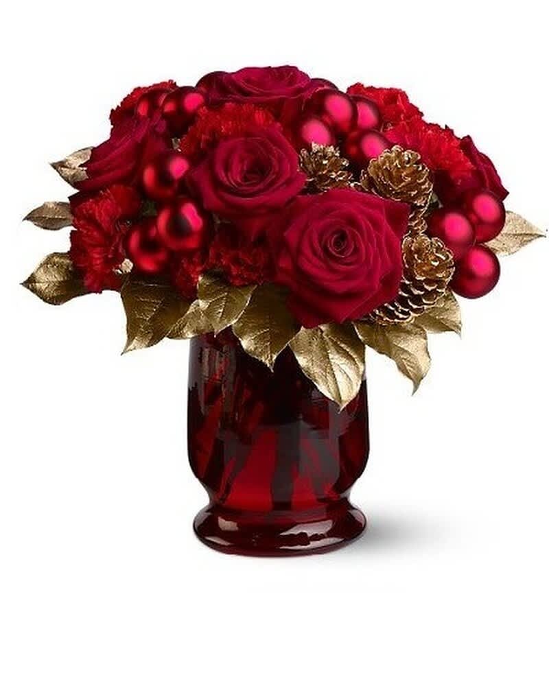Red roses and carnations with red ornaments and gold leaves in a red glass vase