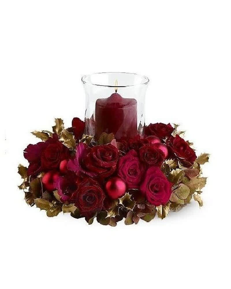 Low red rose centerpiece with gold accents and a red candle in a glass hurricane
