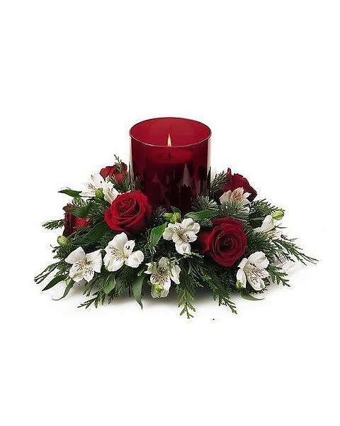 The FTD® Christmas Centerpiece - Classic and contemporary, our Christmas Centerpiece is a natural choice to give as a gift - or keep for yourself. Velvety red roses and white alstroemeria pair with Christmas greens in surrounding a red glass hurricane. 
