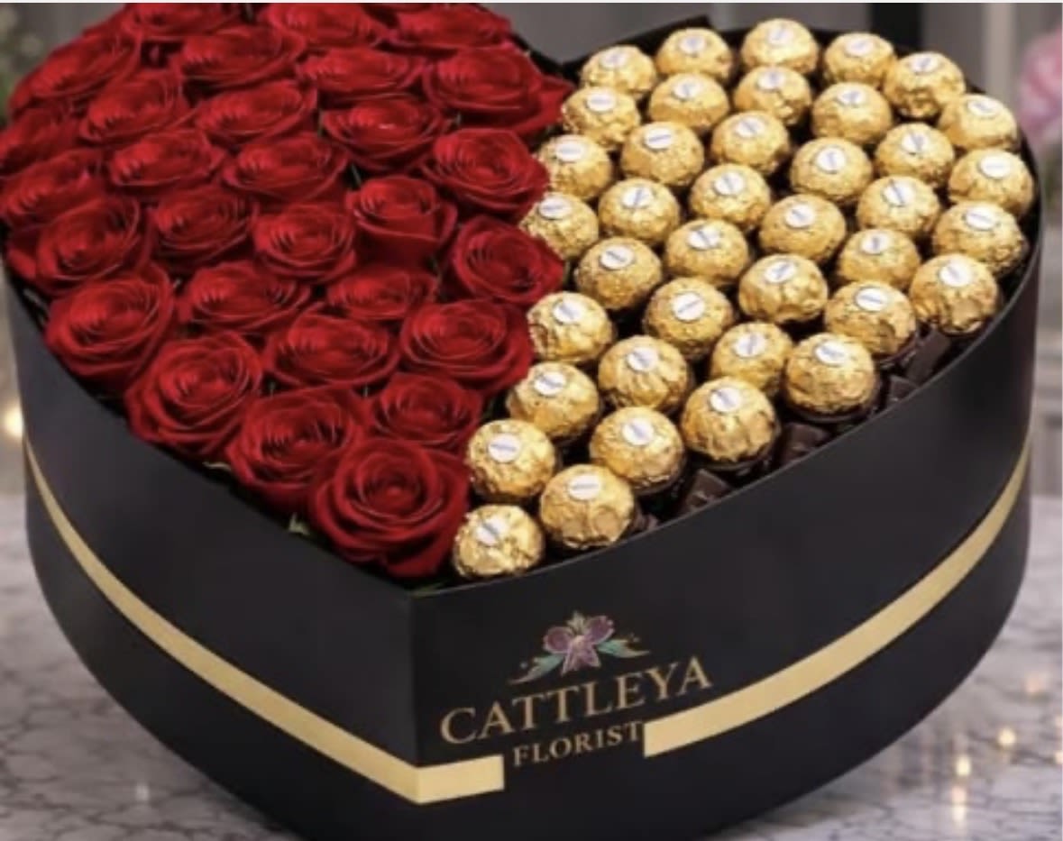 Luxury Heart Box: 25 Roses &amp; Chocolates - An elegant heart-shaped box featuring approximately 25 stunning red roses on one side and a selection of delicious chocolates on the other. A luxurious gift combining beauty and sweetness, perfect for any special occasion.”