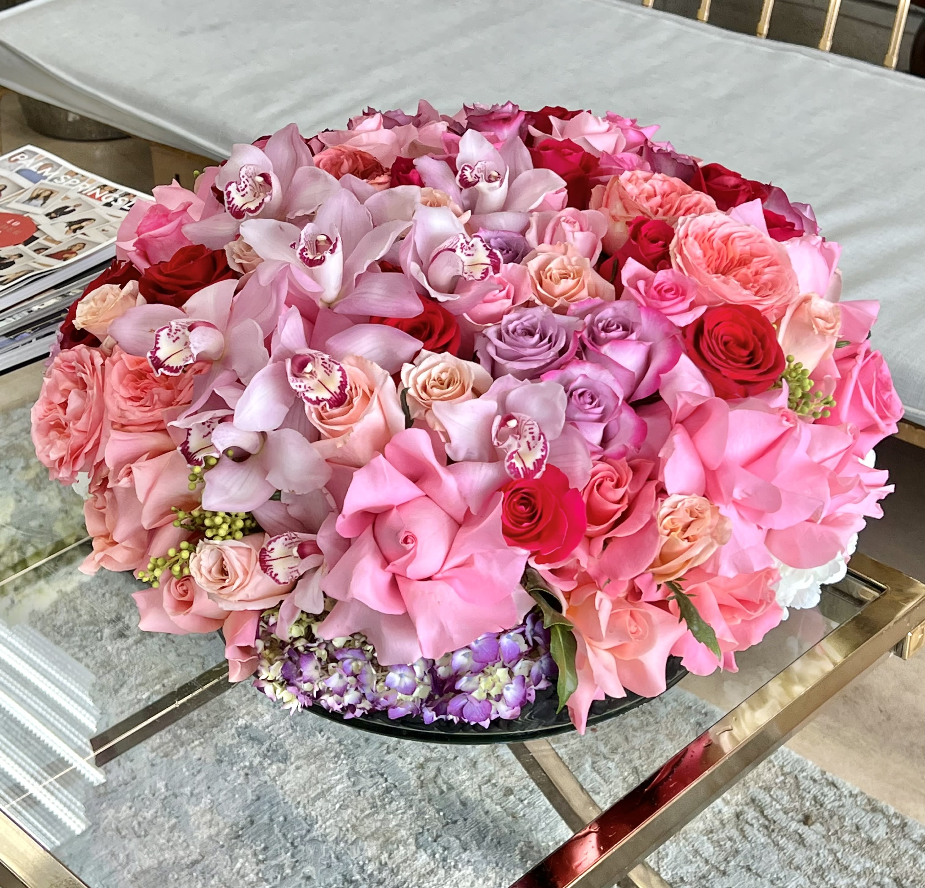 With All My Heart  - This low centerpiece arrangement is full of stunning Roses, Garden Roses, Cymbidium Orchids, and Hydrangea in a glass vase