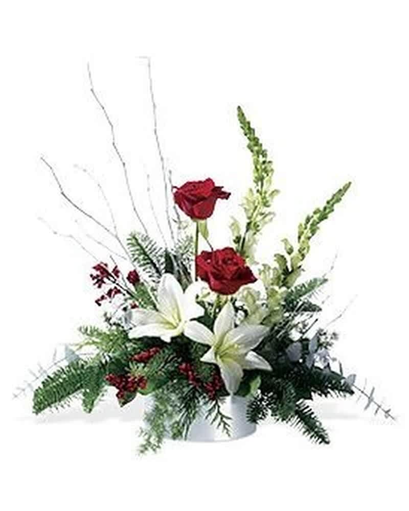 Low centerpiece with red roses and white lilies in a white container with decorative white branches