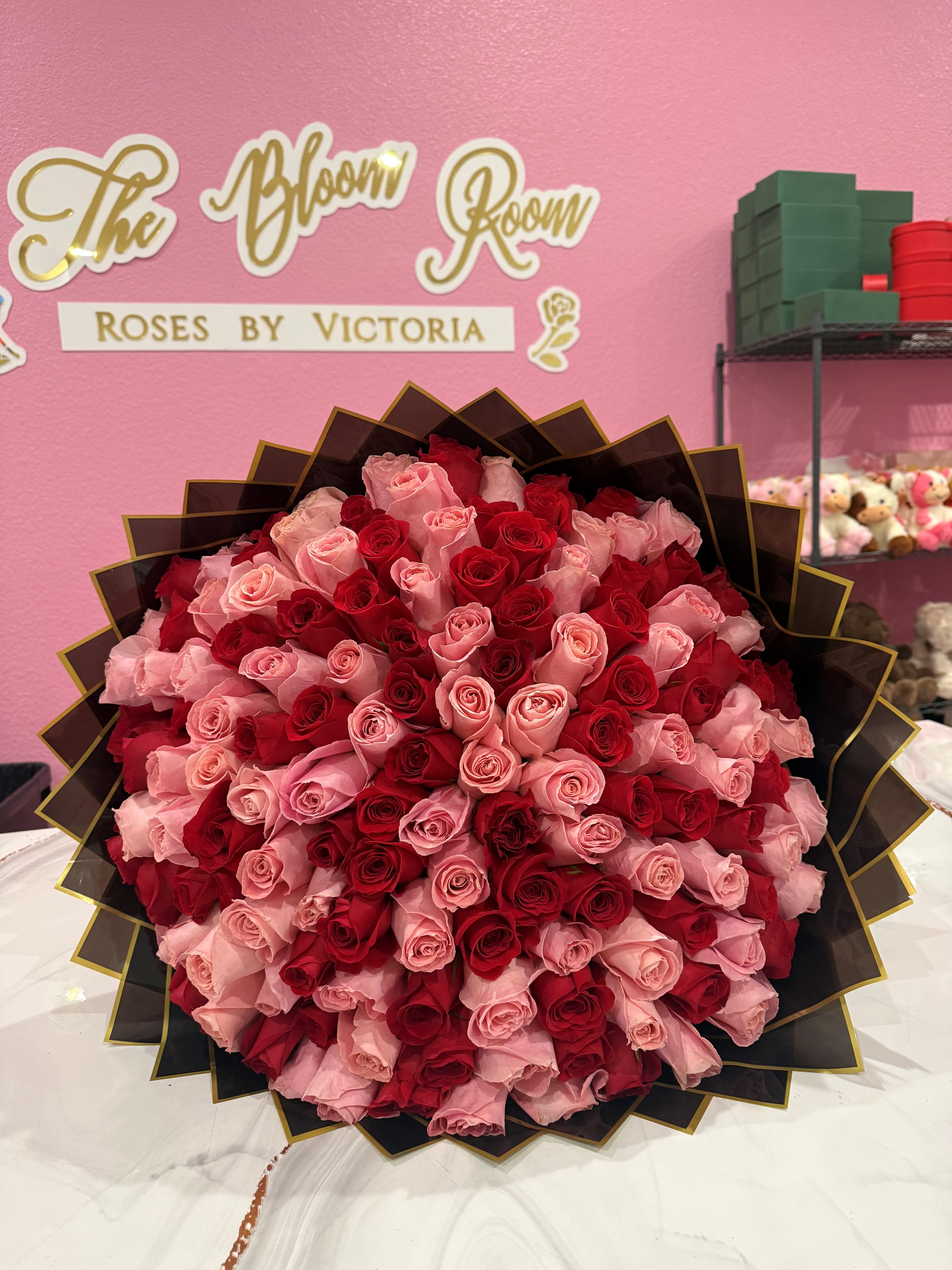 Pink &amp; Red 100 ct Bouquet - A dramatic dome of 100 tightly clustered roses in red and soft pink-this large hand-tied bouquet reads like a bold love letter. Perfect as a romantic anniversary bouquet or a show-stopping Valentine's Day arrangement, the rich red and blush petals create a heart-like palette that will make the person you're thinking of feel deeply celebrated.  