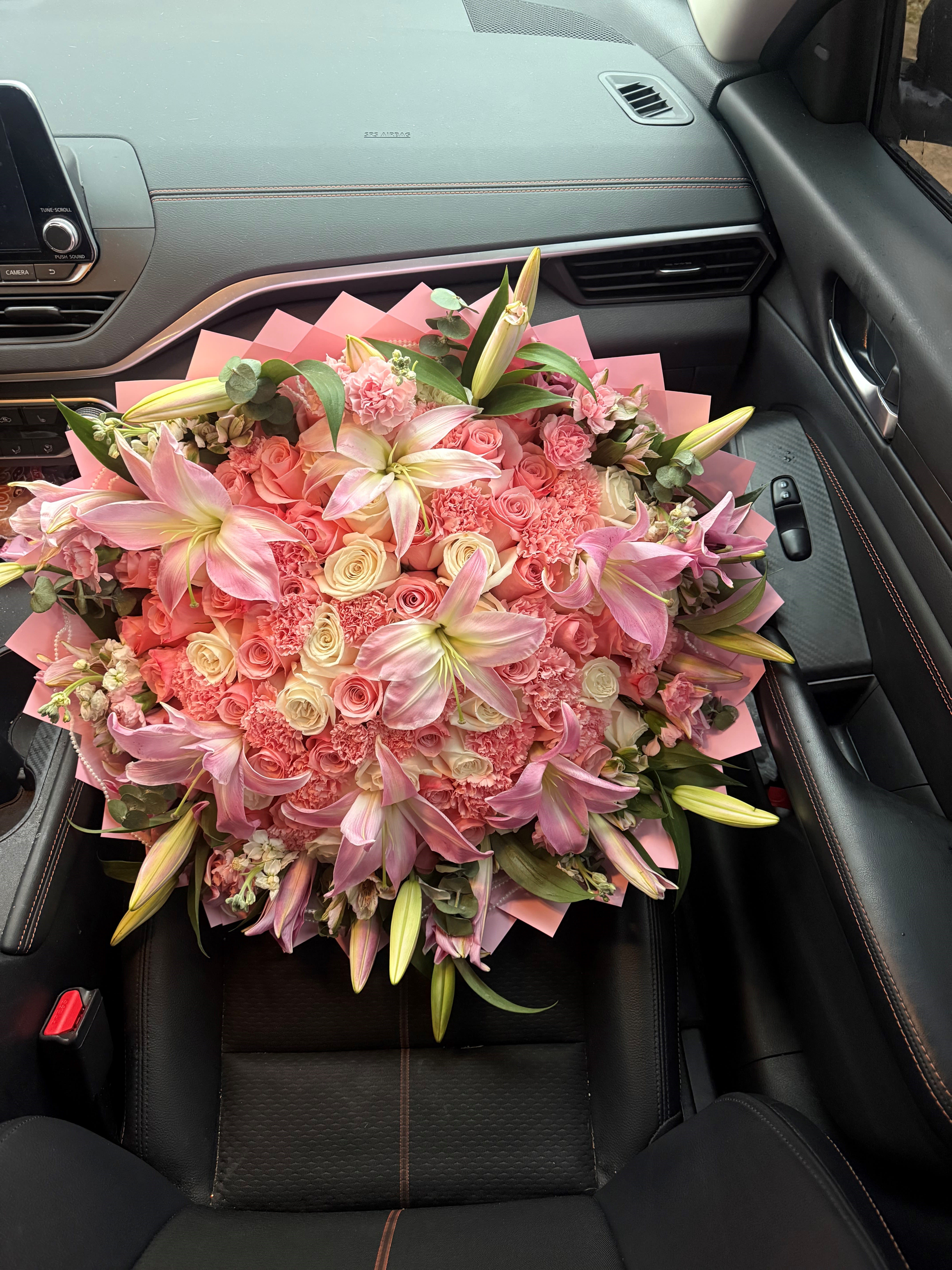 Pinky Promise - A cascade of open lilies and blushing roses makes this hand-tied flower arrangement an unforgettable birthday bouquet or anniversary gift. Pinky Promise pairs romantic pinks, soft peaches, and creamy whites to create a warm, celebratory look she'll feel noticed by-perfect for Mother's Day, Valentine's Day, or any moment you want to mark with affection.  