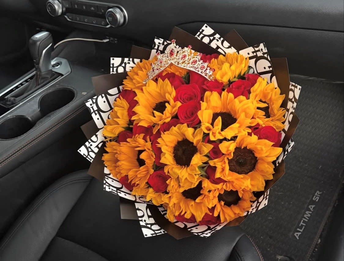 Sunflower Delight - A crown of bright sunflowers paired with vivid red roses makes this sunflower bouquet a joyful statement for birthdays, anniversaries, or any celebration where you want the person you're thinking of to feel truly celebrated. The Sunflower Delight arrangement places the occasion-party, romantic surprise, or milestone-front and center: the playful decorative tiara perched on top turns the bouquet into a giftable centerpiece that reads "today is about you."  