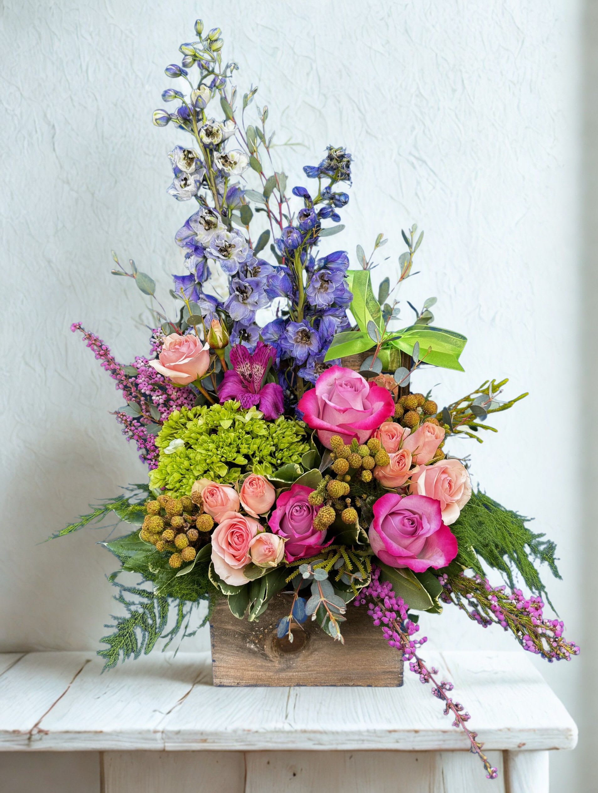 Blossom Box - Tall blue‑purple delphinium spikes rise above clusters of pink and lavender roses in this Blossom Box - a cheerful, romantic flower arrangement perfect for birthday bouquets, spring celebrations, or a thoughtful thank-you gift. 