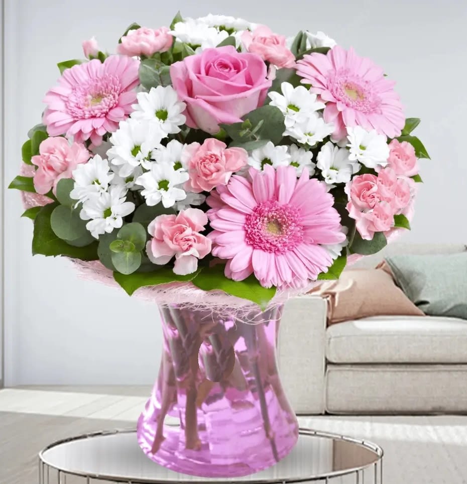 Delightful Arrangement - Experience the elegance of our bouquet .Pink carnations symbolize admiration and  chrysanthemums represent renewal and positivity, while pink gerberas represent joy and innocence. Combined with delicate fillers, this bouquet makes a thoughtful and uplifting gift for celebrations, appreciation, or heartfelt gestures.
