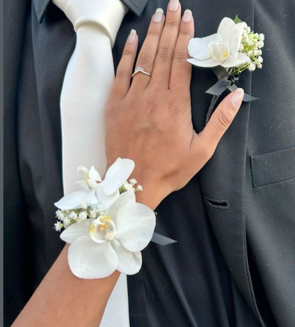 White orchid boutonniere and wrist corsage on formal black attire