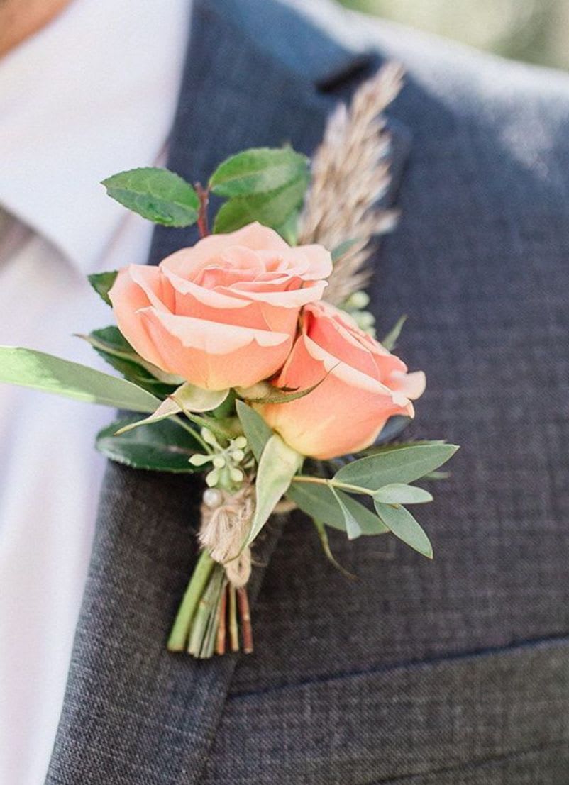 Peach rose boutonniere with greenery and twine wrap