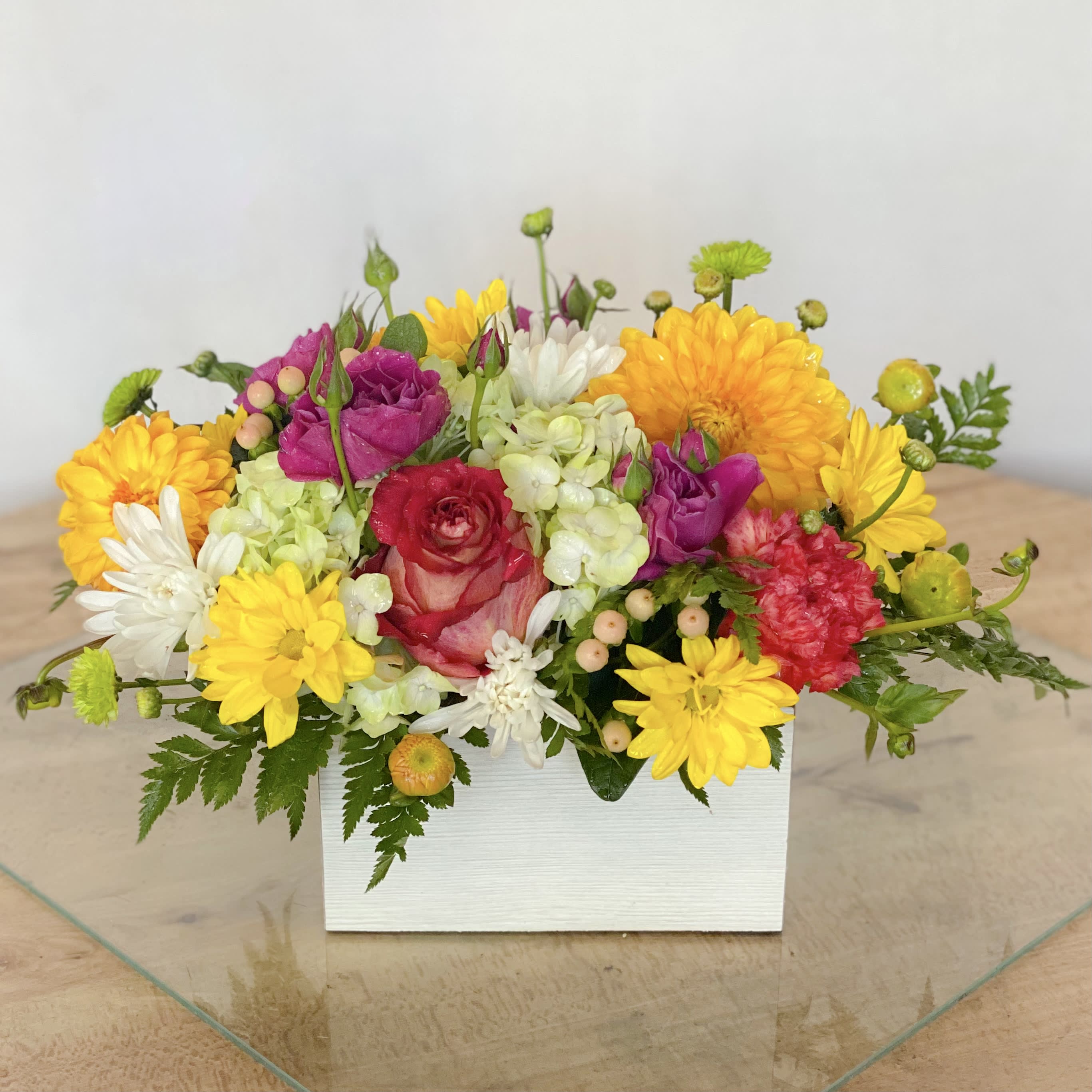 Mixed bouquet in a white rectangular box with yellow, pink, and white flowers