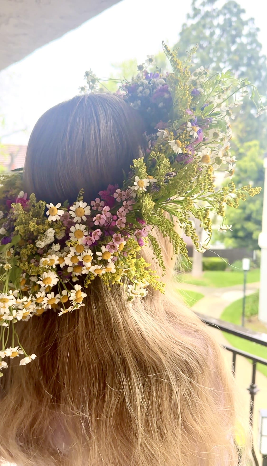 Flower crown with small white, pink, and purple blossoms