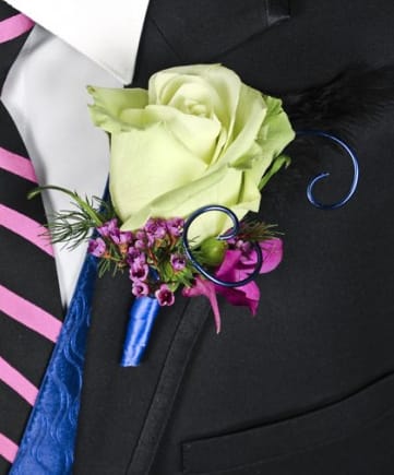 CF2176 - A Night To Remember Boutonniere  A Night To Remember Boutonniere features: a single green rose, Sprigs Lavender Waxflower, Sprigs Ming Fern, Magenta Or Purple Dendrobium Orchid Bloom, Green Hypericum Berry, Black Feather, Blue Decorative Wire, Blue Satin Ribbon, and Black Sheer Ribbon. 