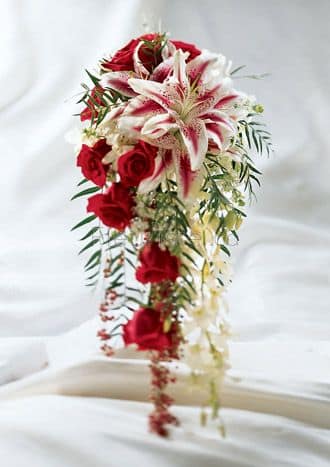 Red roses and white lilies in a cascading bridal bouquet