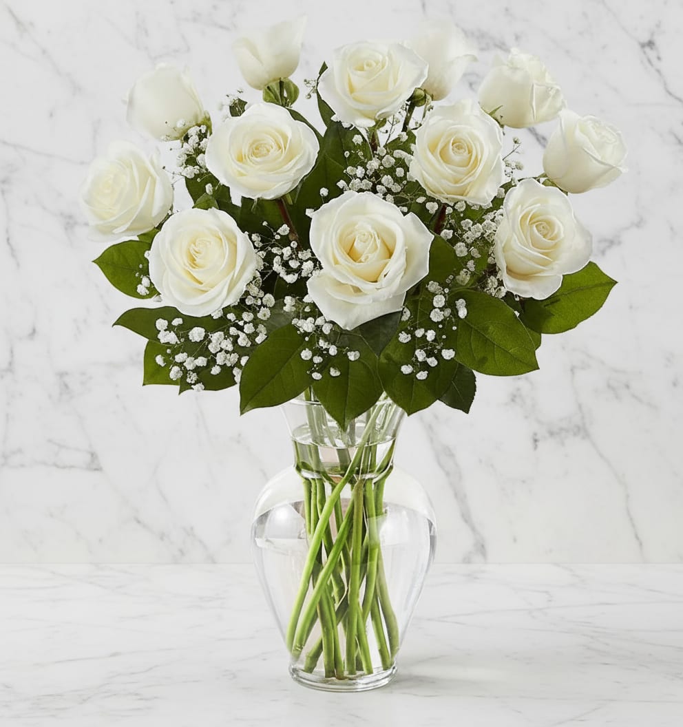 Dozen White Roses With Baby Breath - Our pristine white roses are an elegant surprise for someone who brings pure joy to your life. Beautifully arranged by our expert florists with lush greenery inside a classic glass vase, 12 or 18 delicate blooms are hand-delivered and ready to delight the people you care about for big celebrations and every “just because” moment in between.