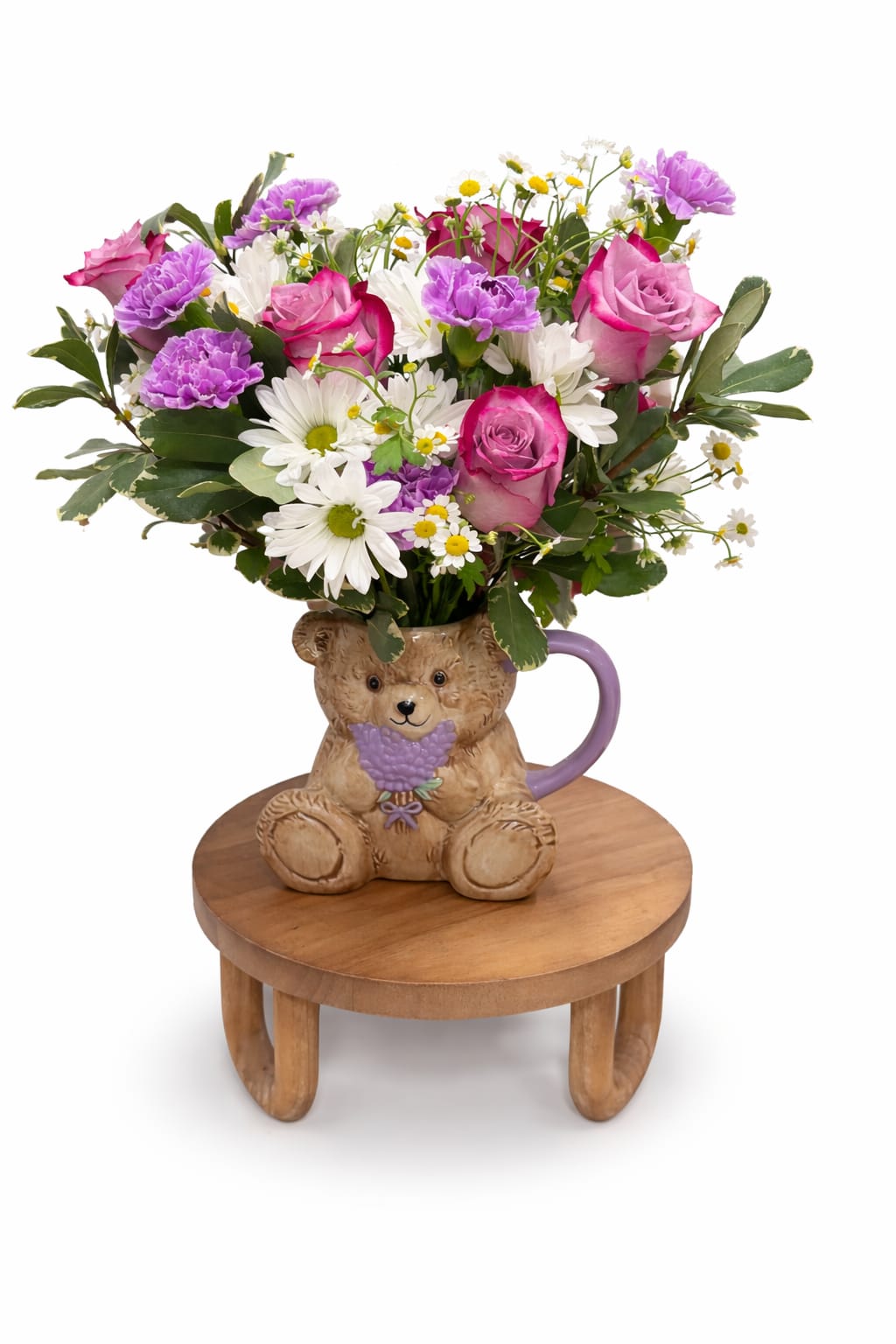 Bear Hugs &amp; Blooms  - A sweet and cheerful floral gift arrange in a  adorable teddy bear keepsake mug. Featuring lavender roses, lavender carnation, white daisies, chamomile accents, and fresh greenery. Charming design is perfect for birthdays, get well wishes ,or simply sending a warm hug through flowers.