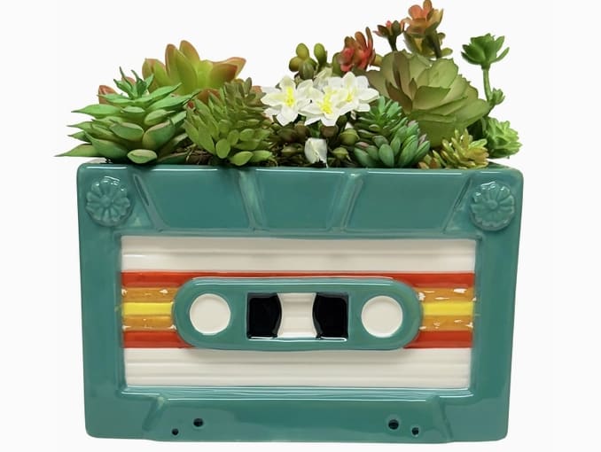 Retro Cassette Tape Planter - Description A vibrant 80s-style cassette turned planter that rewinds you straight to the mixtape era. Perfect for plants, pens, or anyone still living their retro best life! New for 2026  • Material: Ceramic • Packaging: Color Box Made in China Weight: 1 lb (453.59 g) Dimensions: 6 x 3.5 x 3.8 in (15.2 x 8.9 x 9.5 cm)