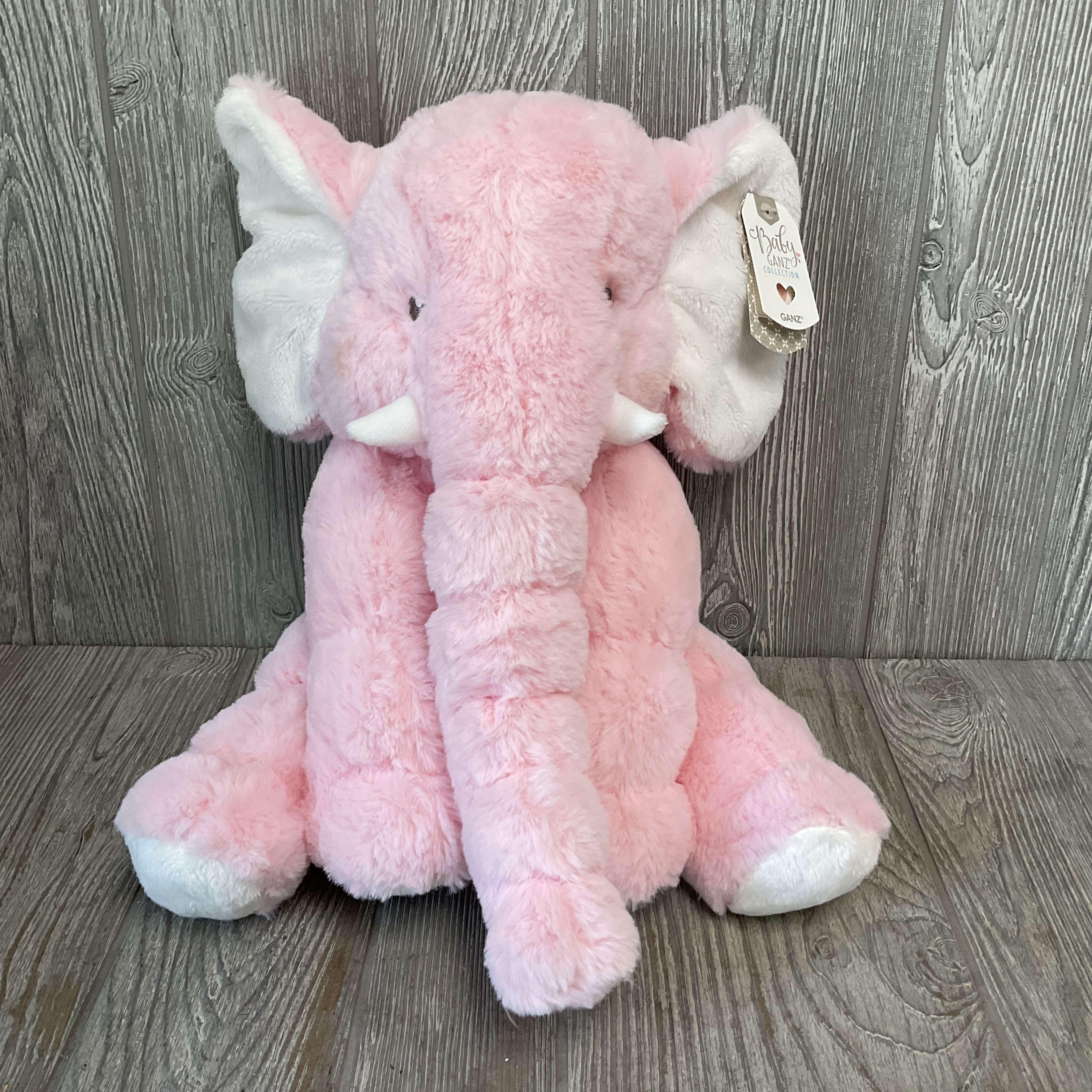 Pink plush elephant stuffed animal with white ears and tusks