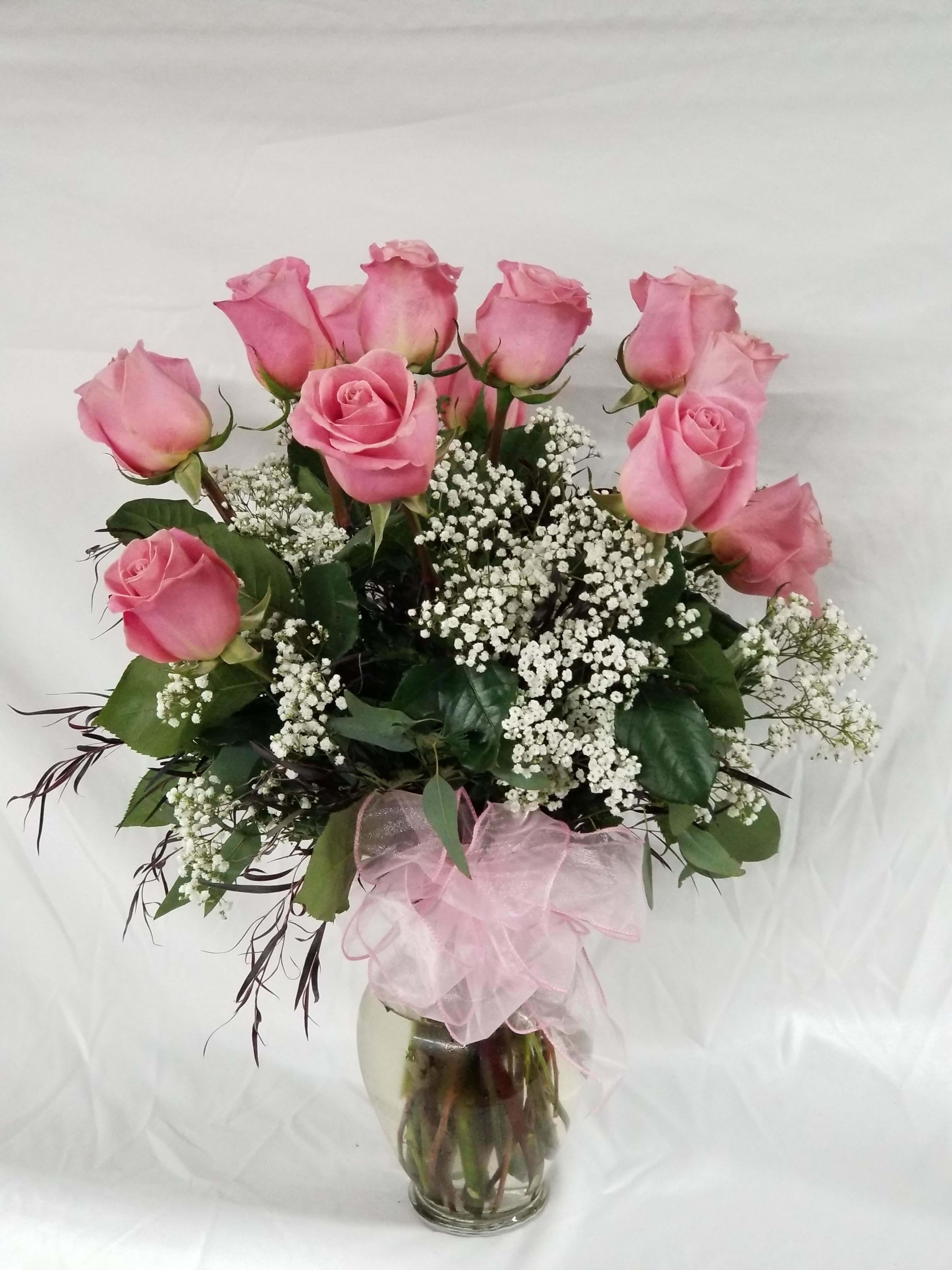 Long Stem Dozen Pink Roses - Select this classic rose arrangement of one dozen, long stem roses with filler and greenery. Exact rose color may vary. 