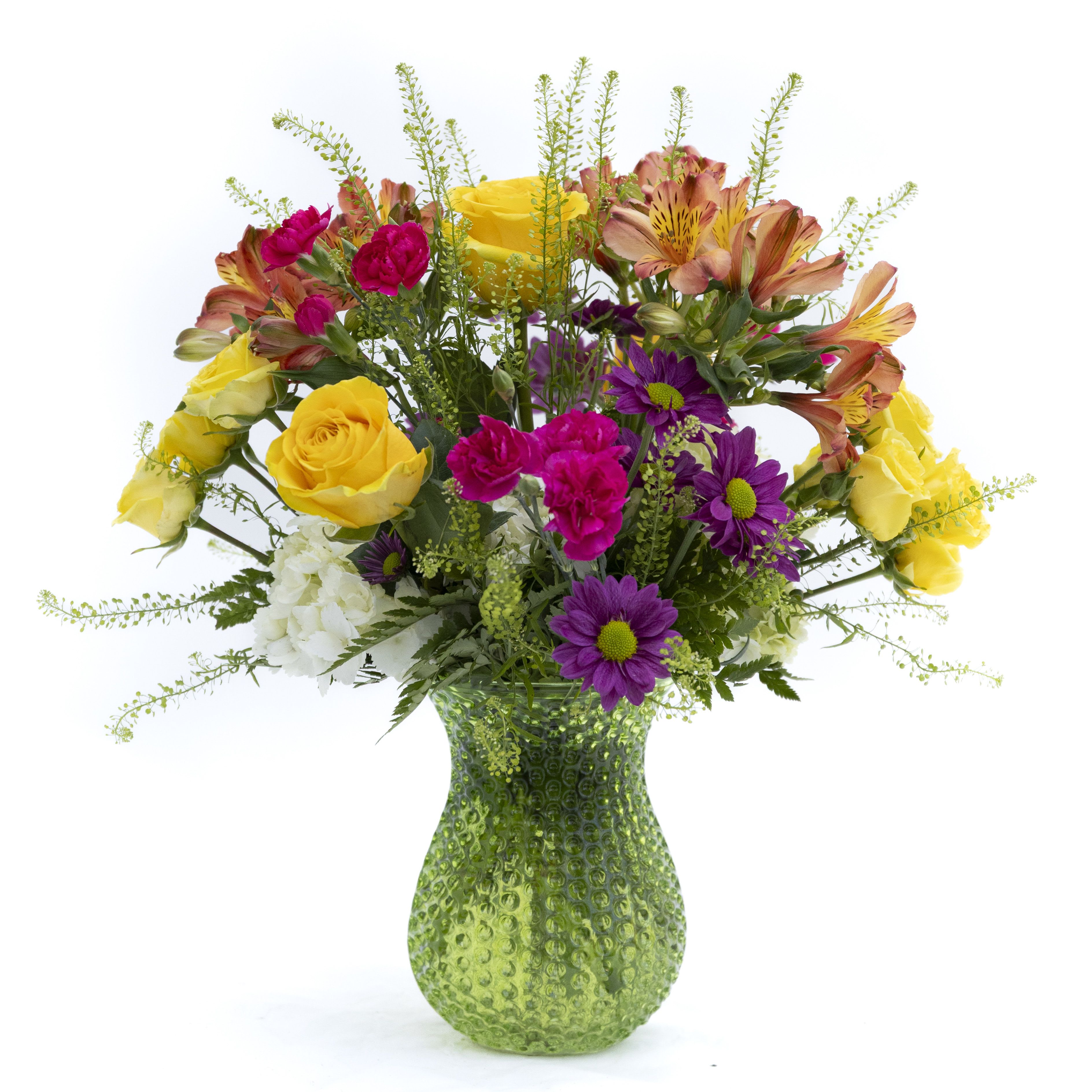 The Poppy - Bright, cheerful, and full of life, Sunlit Garden is a vibrant celebration of color and texture. Golden yellow roses shine alongside bold magenta blooms, playful purple daisies, and warm-toned alstroemeria, all gathered with fresh, airy greenery. Designed in a lively green glass vase, this arrangement brings a burst of sunshine to any room. Perfect for celebrations, get-well wishes, or just because, it radiates happiness and makes an uplifting statement wherever it’s placed.  Delivery to Syracuse, North Syracuse, East Syracuse, Dewitt, Manlius, Jamesville, Fayetteville, Camillus, Marcellus, Minor, Mattydale, Liverpool