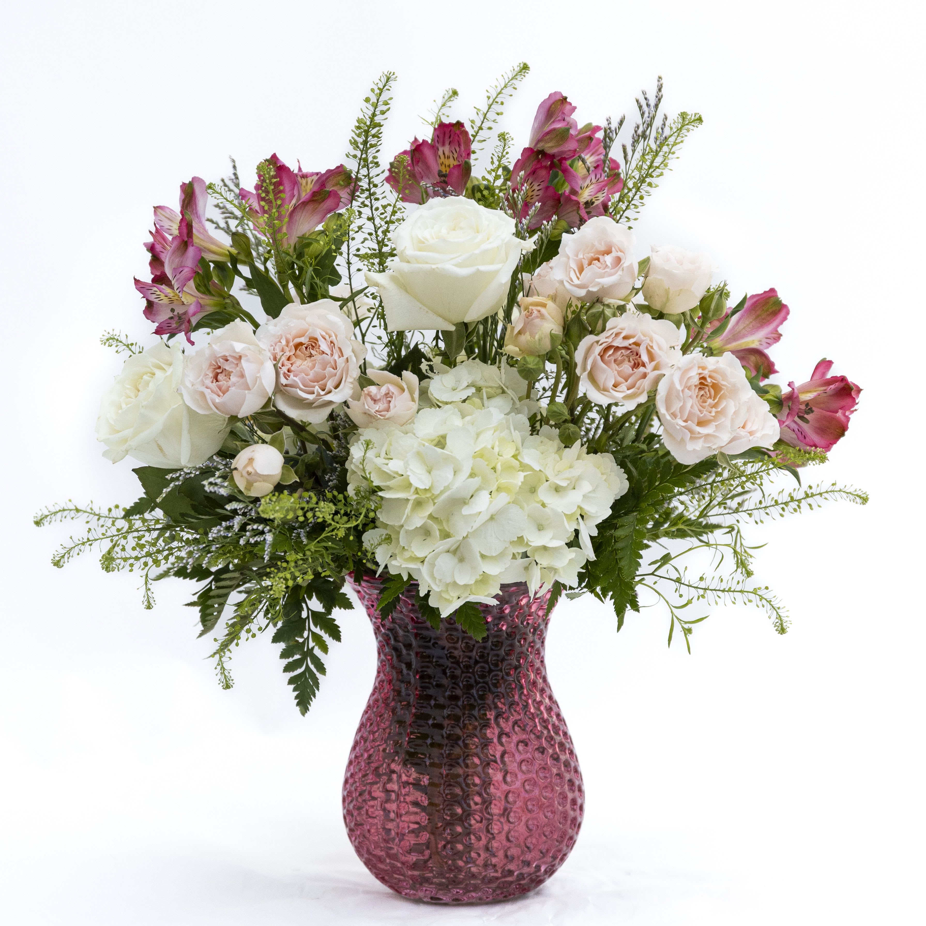 The Olivia - A graceful blend of soft romance and fresh elegance, Blush Harmony features delicate blush garden roses, creamy white roses, and airy hydrangea, accented with pops of pink alstroemeria and wispy greenery. Arranged in a textured rose-toned glass vase, this design brings a light, garden-inspired feel to any space. Perfect for celebrating love, gratitude, or simply brightening someone’s day, its gentle color palette and natural movement create a timeless, effortlessly beautiful statement.  Delivery to Syracuse, North Syracuse, East Syracuse, Dewitt, Manlius, Jamesville, Fayetteville, Camillus, Marcellus, Minor, Mattydale, Liverpool