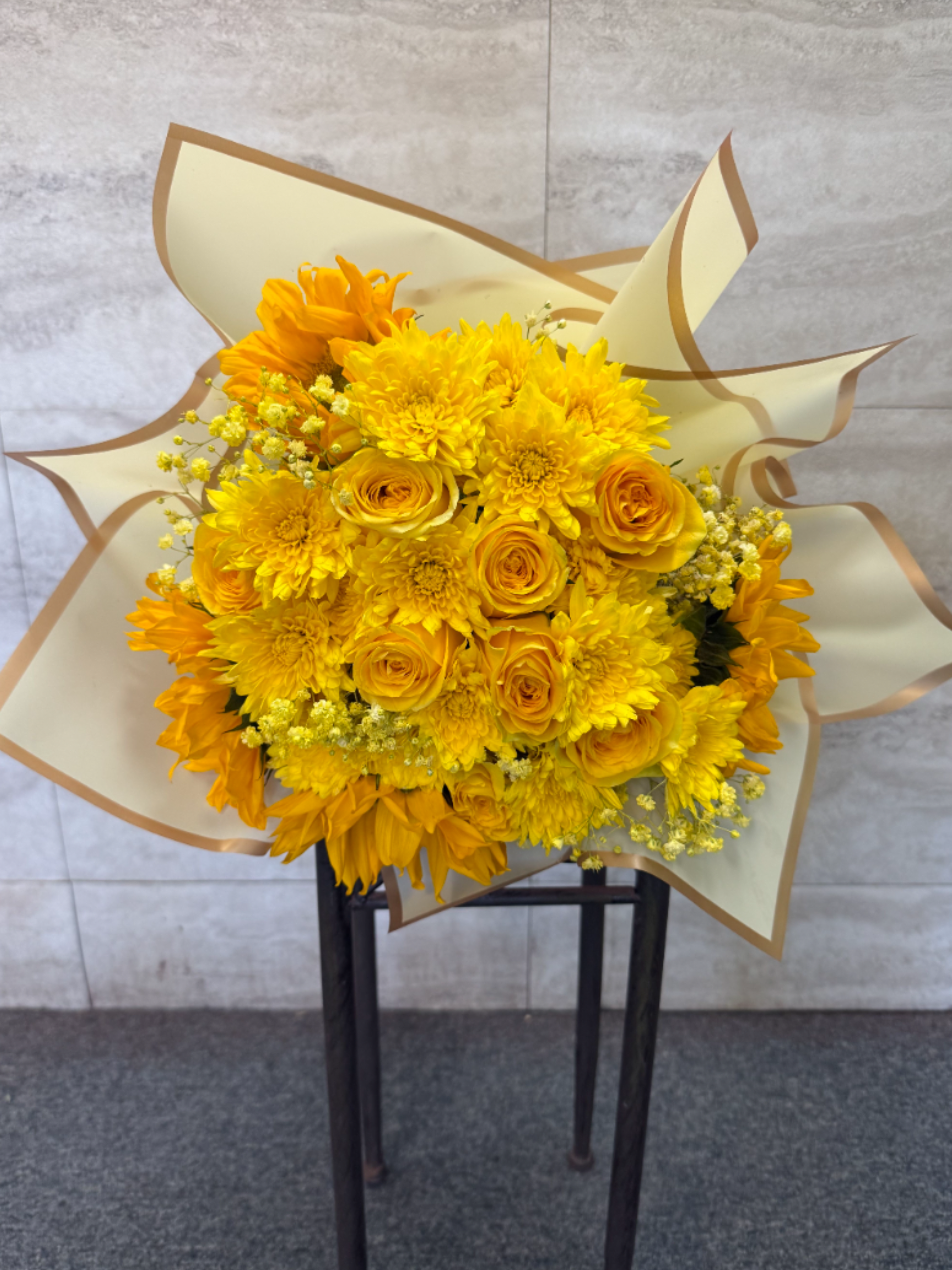 The Sun Kissed Bouquet  - (WRAP-NO VASE) A wrapped bouquet filled with yellow florals, perfect for celebrating Yellow Flower Day and adding the perfect touch of joy to any occasion. 