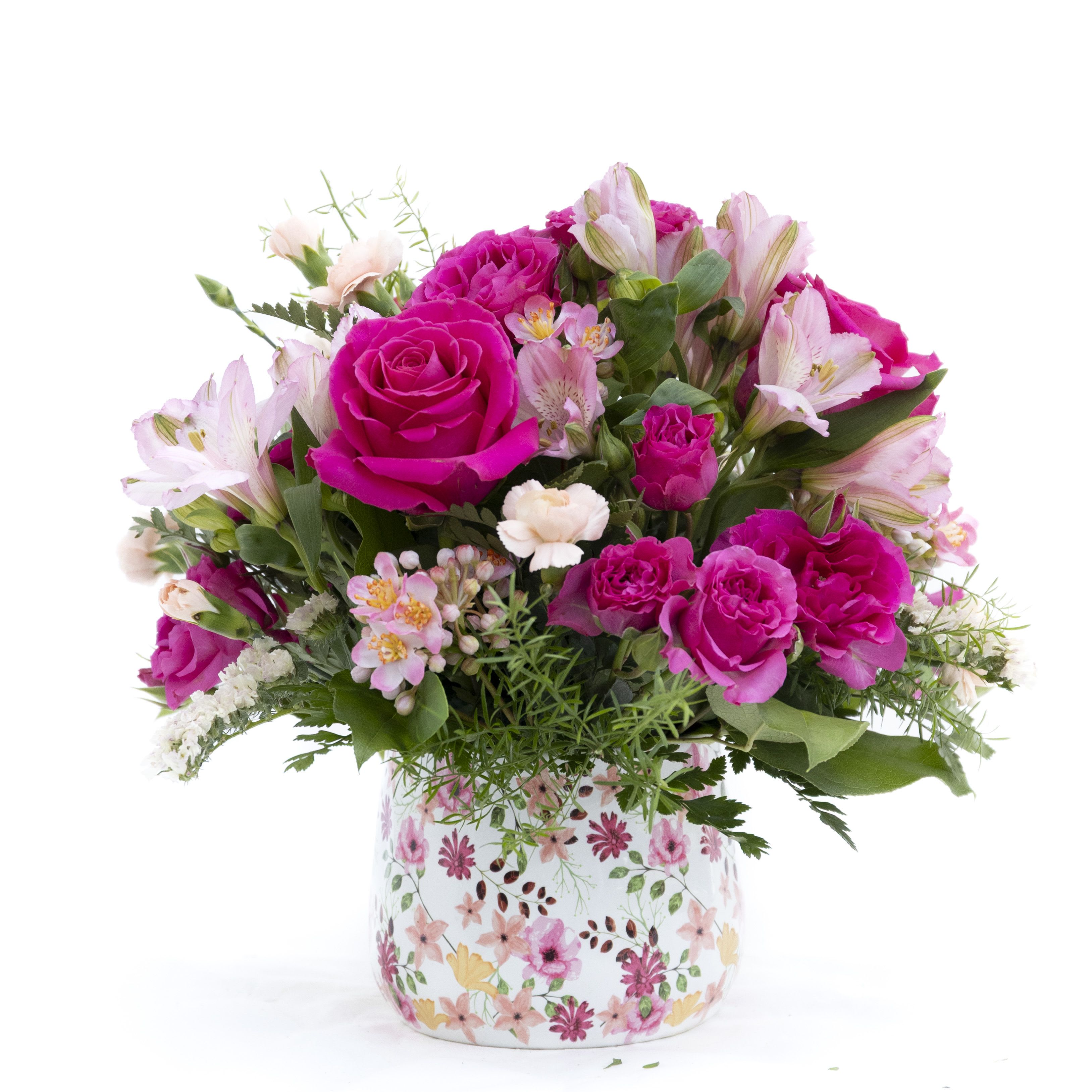 The Gemma - A vibrant, joyful arrangement bursting with rich fuchsia roses, soft blush accents, and fresh seasonal blooms. Artfully designed with lush greenery and delicate textures, this bouquet creates a striking balance of bold color and gentle elegance. Arranged in a charming floral vase that complements its lively palette, it’s the perfect gift to celebrate love, brighten someone’s day, or add a cheerful pop of color to any space.  Delivery to Syracuse, North Syracuse, East Syracuse, Dewitt, Manlius, Jamesville, Fayetteville, Camillus, Marcellus, Minor, Mattydale, Liverpool