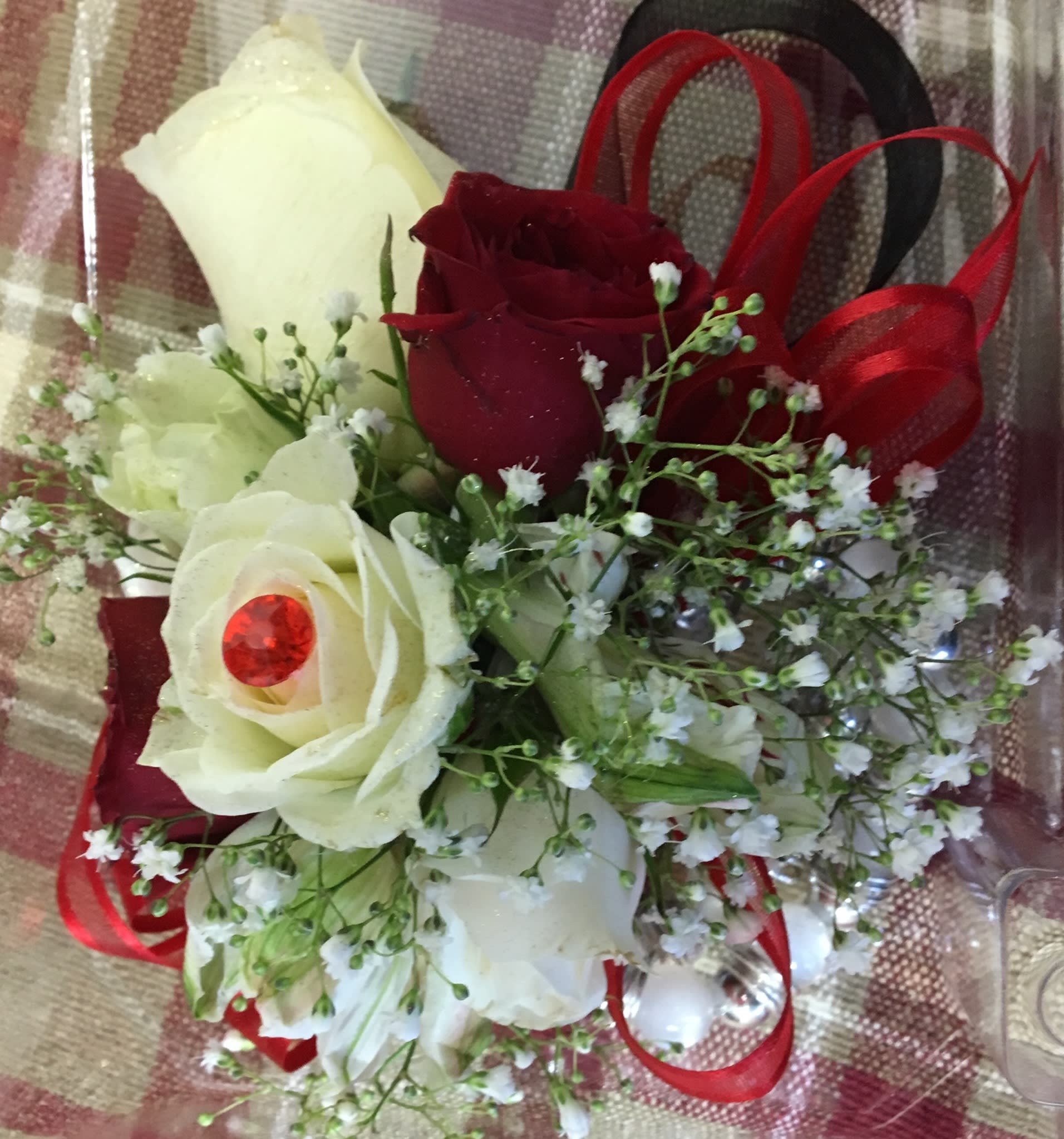 Bouquet of red and white roses with baby's breath and red ribbon