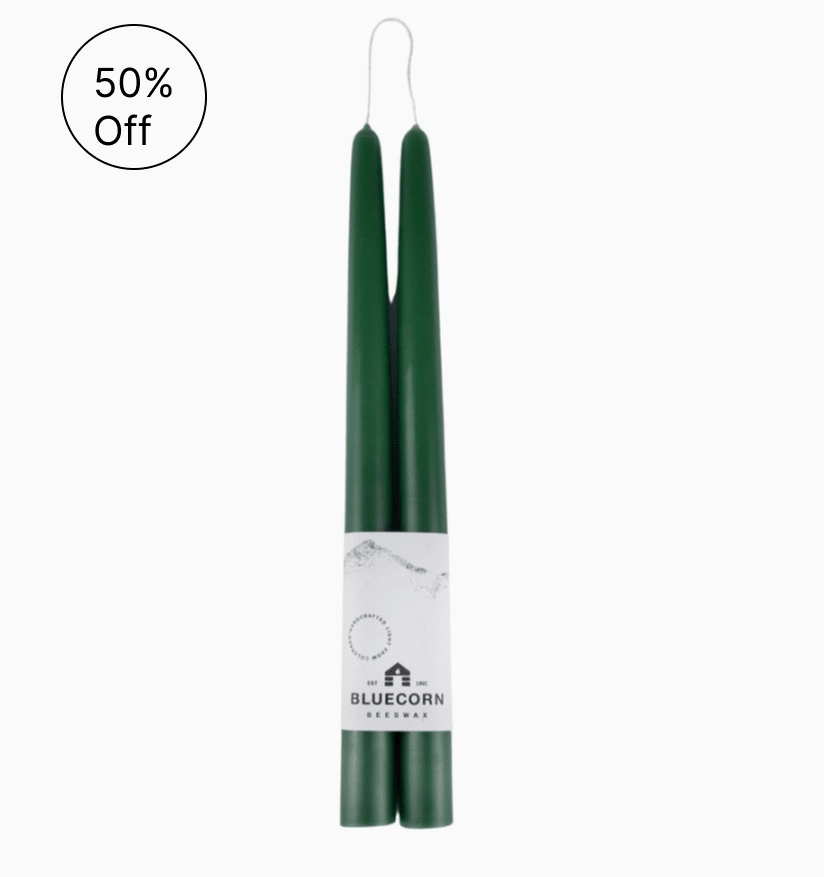 Pair of dark green taper candles bound together with a white Bluecorn Beeswax label