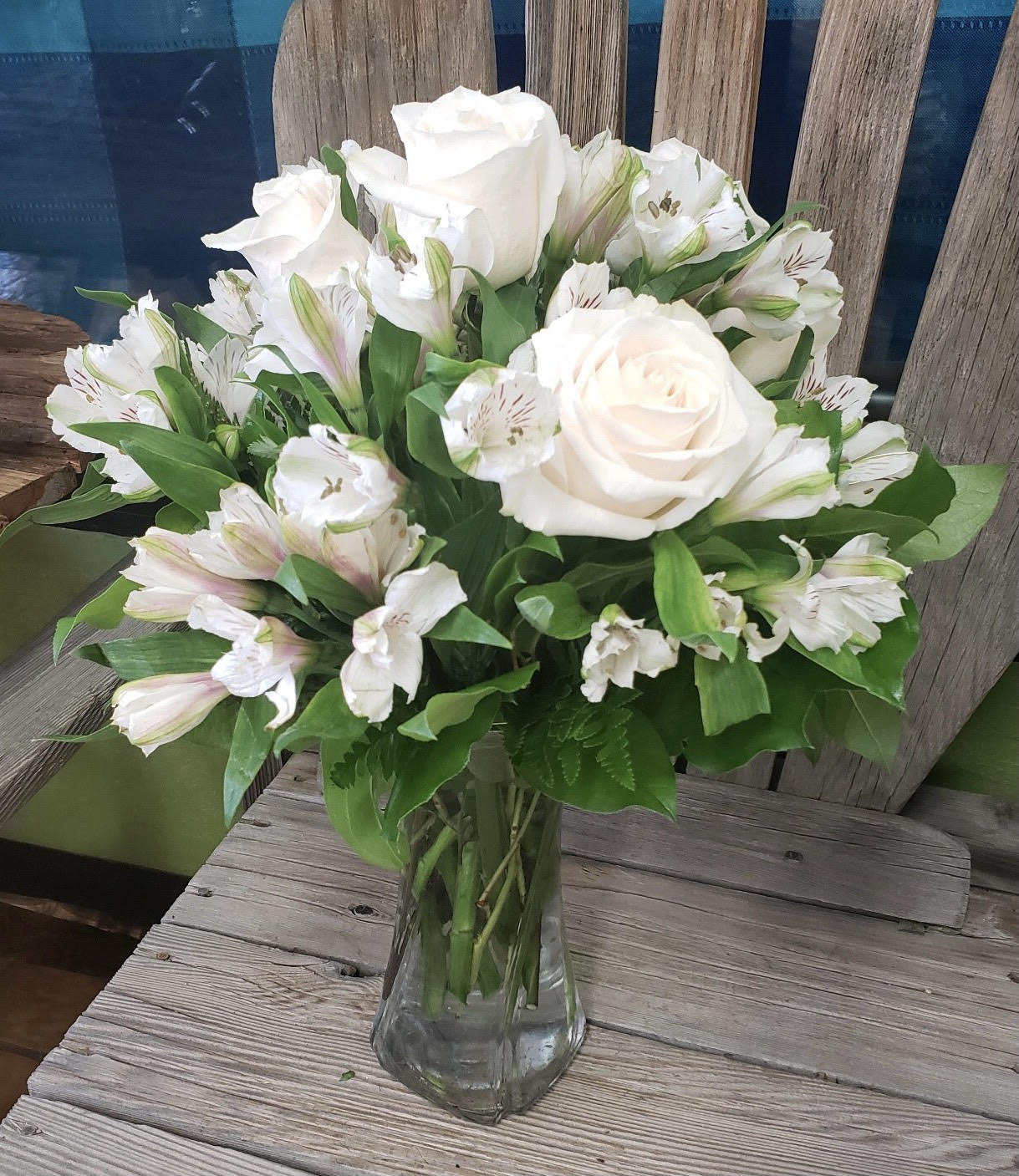 White roses and alstroemeria in a clear glass vase