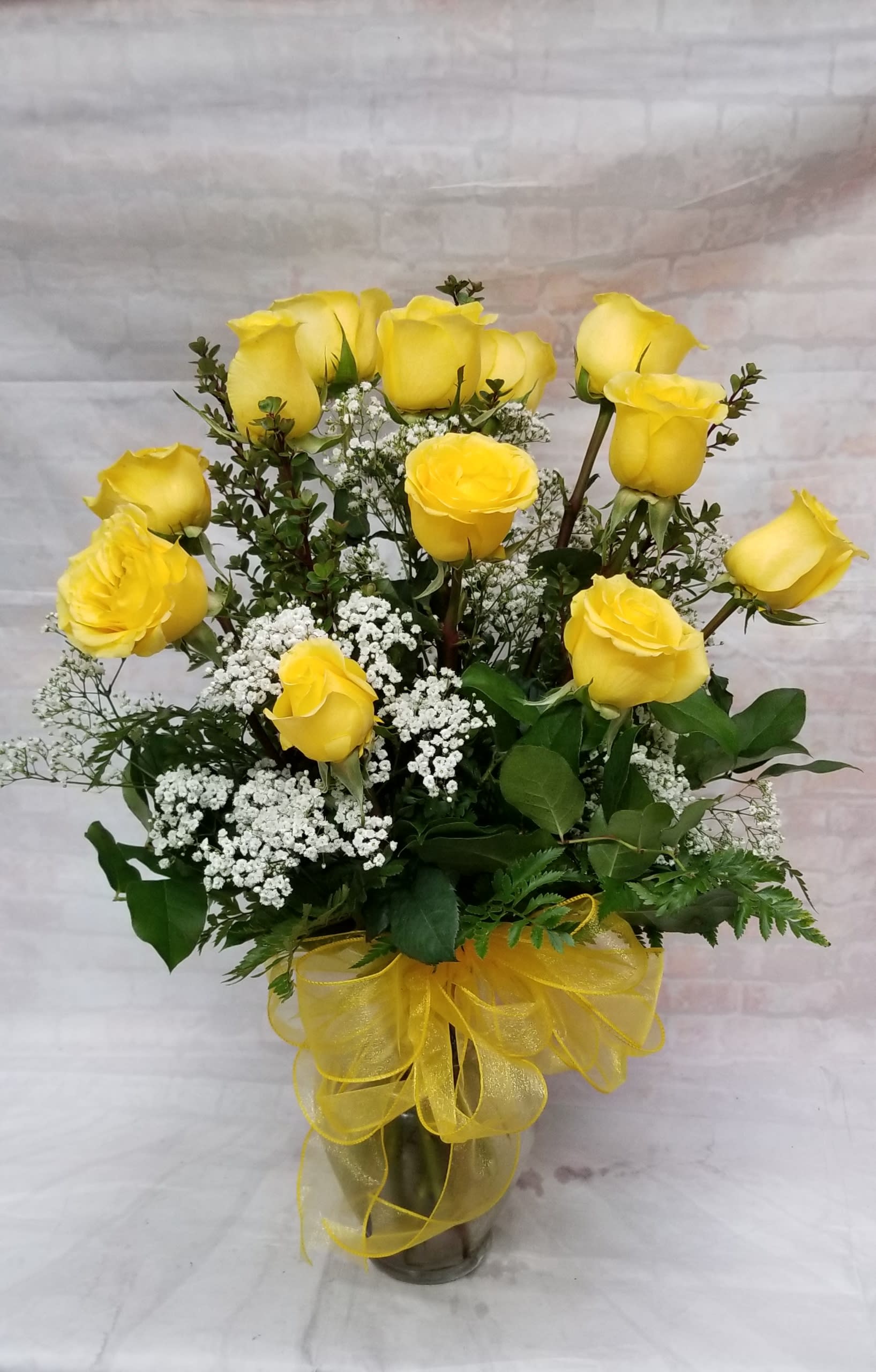 Long Stem Dozen Yellow Roses - Select this beautiful arrangement of one dozen yellow roses and babies breath.