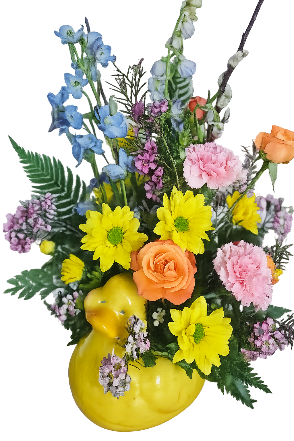 Sunny Duckling Garden - A bright and uplifting floral arrangement styled in a glossy yellow duck container, perfect for celebrating spring. Vibrant yellow daisy poms bring a sunny pop, while soft pink carnations add fullness and a gentle, romantic touch. Peach roses introduce warmth and elegance, beautifully balanced by airy lavender waxflower and delicate filler blooms.  Tall stems of light blue delphinium create height and movement, giving the arrangement a whimsical garden feel. Lush greenery and textured foliage provide a fresh, natural backdrop, while pussy willow branches add a seasonal, rustic accent.