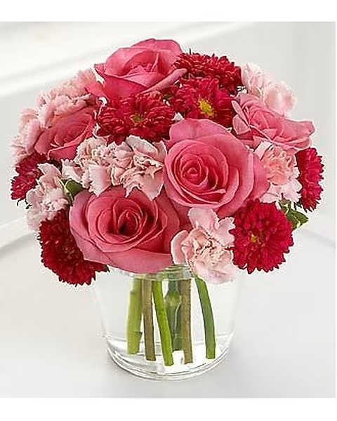 Precious Heart - Featured in US Weekly, the Precious Heart Bouquet by FTD holds radiant hot pink roses, deep red matsumoto asters and light pink mini carnations designed to warm her heart. All are lovingly arranged in a clear round glass vase.
