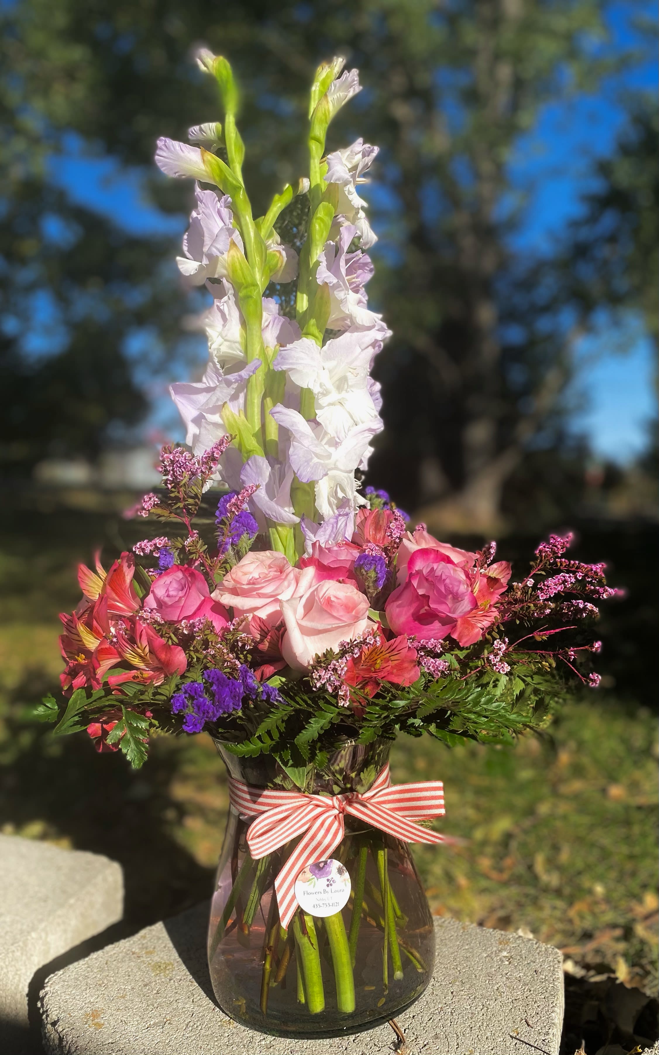 Royal Grande - Royal colors, including roses, and tall and short flowers in a round vase