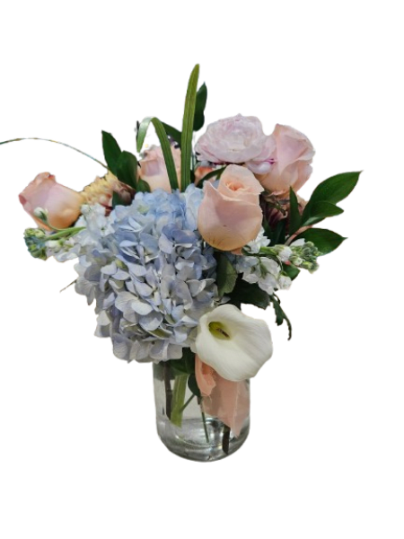 Blush &amp; Blue Elegance - Soft, romantic, and effortlessly refined, the Blush &amp; Blue Elegance arrangement is a timeless expression of beauty. Featuring a lush blue hydrangea, delicate blush roses, a graceful white calla lily, and a soft garden-style focal bloom, this design is artfully accented with fresh greenery and airy white florals.  Arranged in a clear glass vase and finished with a soft blush ribbon, this bouquet brings a sense of calm, sophistication, and understated luxury to any space. Perfect for birthdays, anniversaries, sympathy, or simply letting someone know you’re thinking of them.