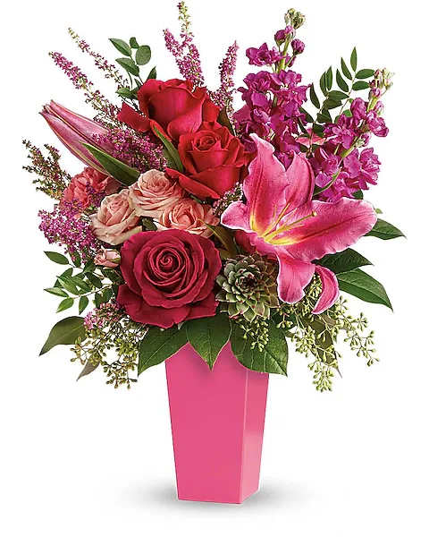 Forever Fuchsia Bouquet - Pretty in pink! A surprise they'll remember forever, this fantasy of fuchsia lilies, roses and carnations is artistically arranged in a sleek contemporary vase. This stunning bouquet features pink oriental lilies, hot pink roses, pink carnations, fuchsia stock, light pink spray roses, pink heather, lemon leaf, huckleberry, seeded eucalyptus, and a small green potted echeveria succulent. Delivered in a raspberry tapered vase.