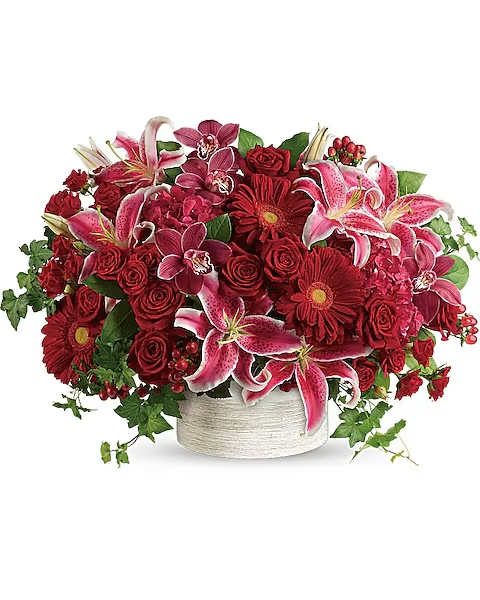 Stunning Statement Bouquet - Brimming with hydrangea, orchids, roses and lilies in fabulous fuchsias and radiant reds, this breathtaking bouquet definitely makes a statement! This stunning arrangement of red hydrangea, red cymbidium orchid blossoms, red roses, red spray roses, hot pink oriental lilies, red gerberas, and red hypericum is accented with green ivy and lemon leaf. Delivered in a white cylinder planter.